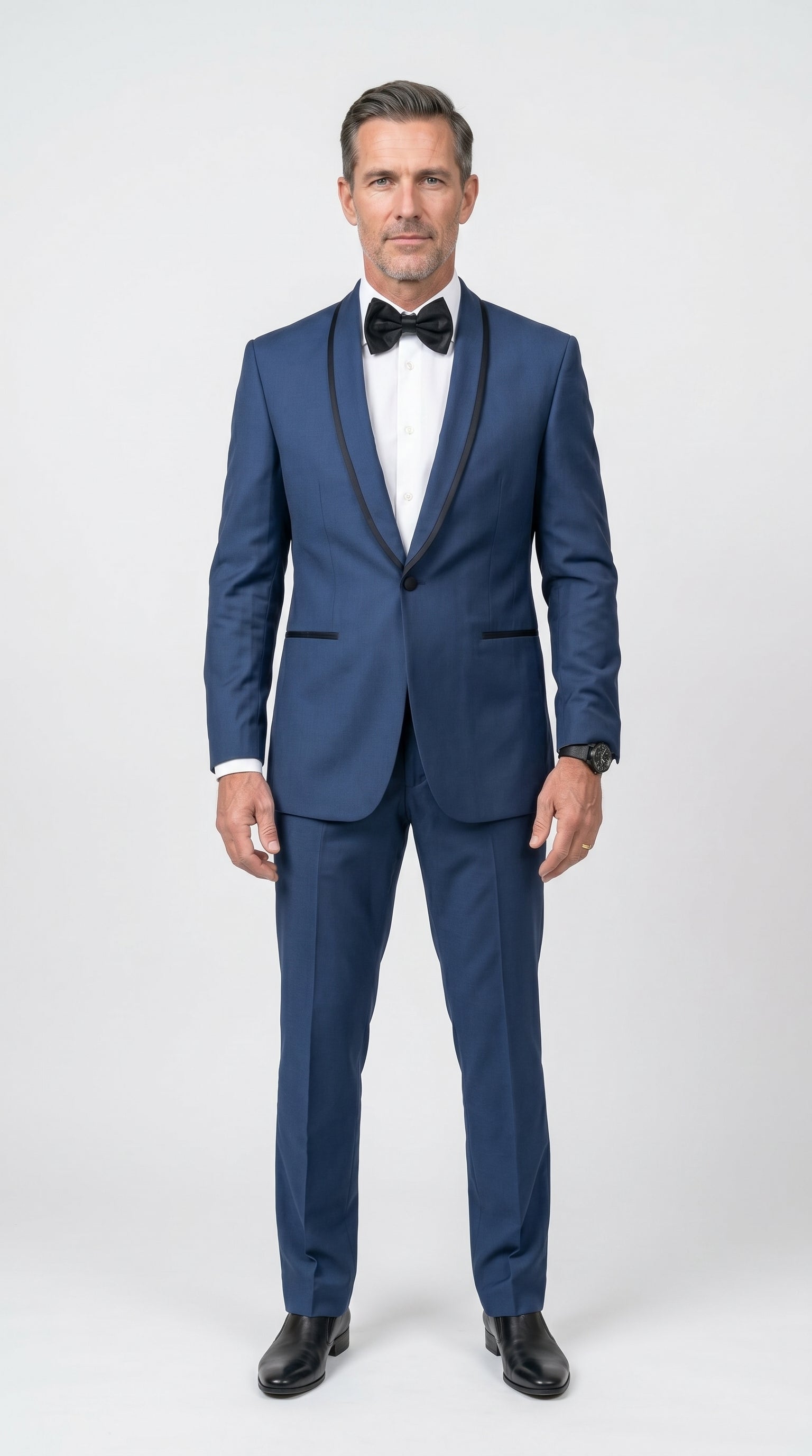 Men's Tuxedo featuring a medium royal blue fabric, a slim-fit structured silhouette, a single-button closure, and a sleek black satin shawl lapel with matching black jetted pockets.