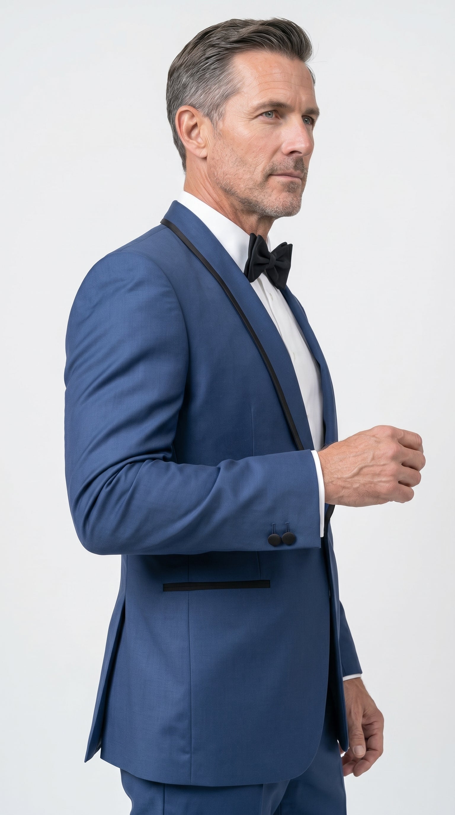 Men's Tuxedo featuring a medium royal blue fabric, a slim-fit structured silhouette, a single-button closure, and a sleek black satin shawl lapel with matching black jetted pockets.