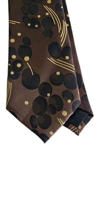 Brown tie with black and gold abstract pattern on a white background