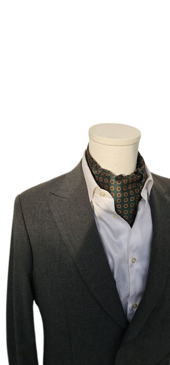 Gray suit jacket over a white shirt with a patterned cravat on a mannequin against a white background