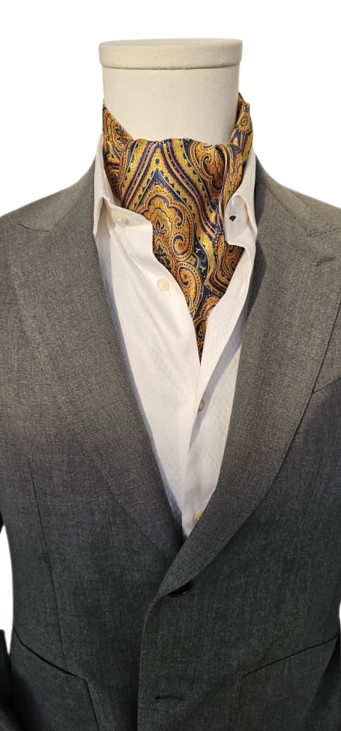 Mannequin wearing a gray suit with a white shirt and patterned ascot tie.