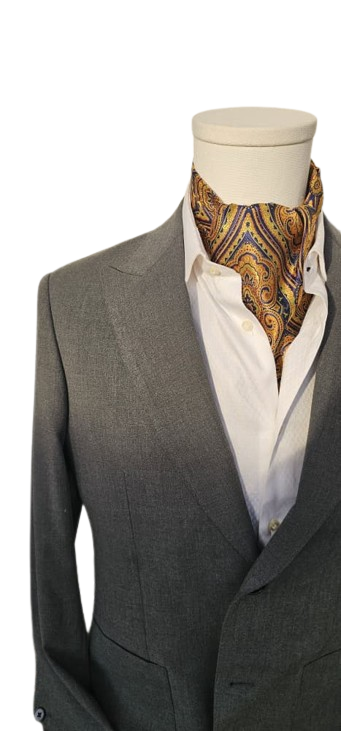 Gray suit jacket with a white shirt and patterned ascot on a mannequin against a white background