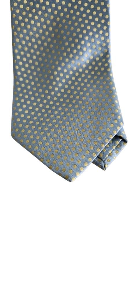 Folded Blue tie with gold polka dots on a white background
