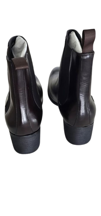 Pair of black leather ankle boots on a white background