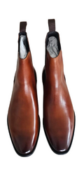 Pair of brown leather boots with black soles on a white background
