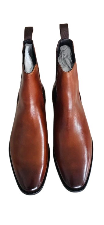 Pair of brown leather boots with black soles on a white background