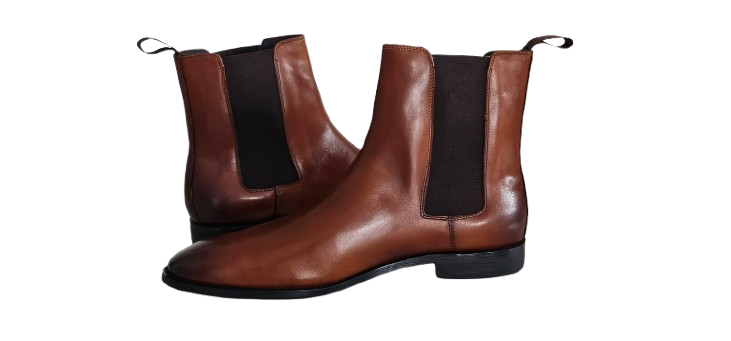 Pair of brown leather Chelsea boots with black elastic sides on a white background