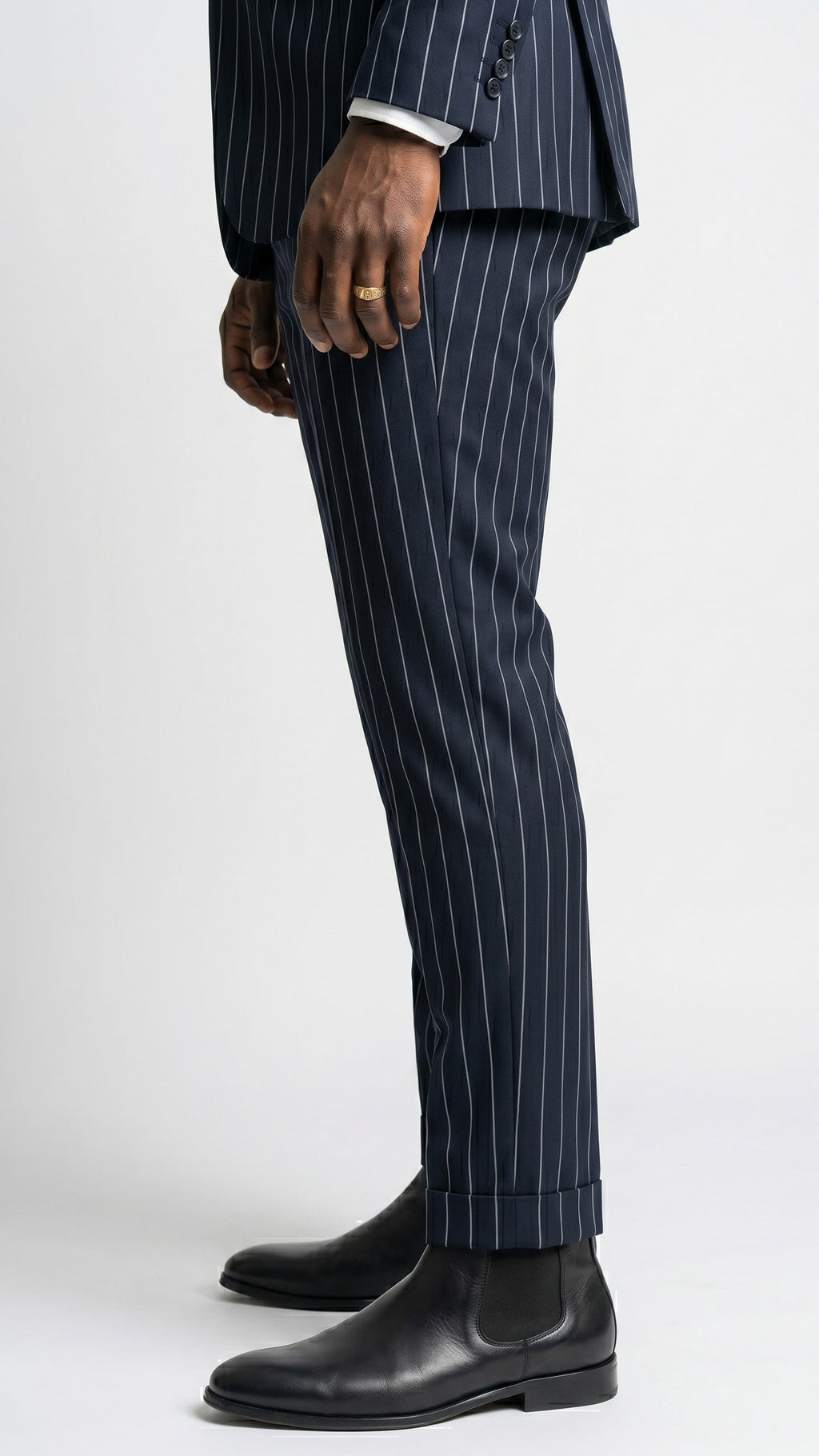 Navy pinstripe suit with black leather shoes on a white background