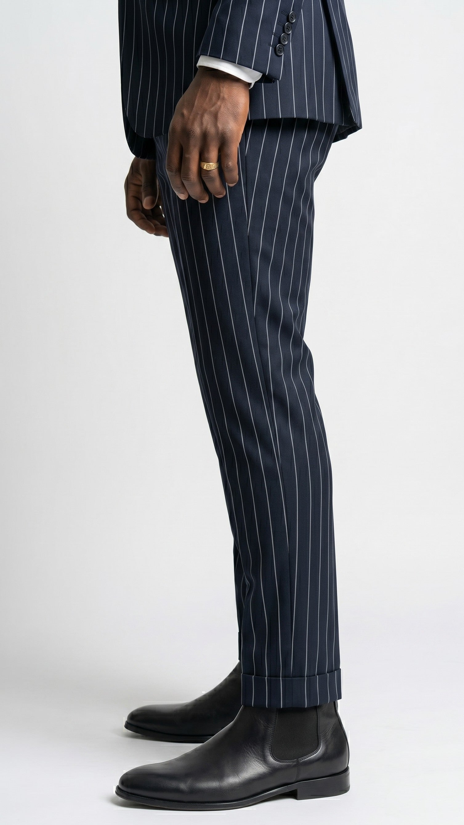 Navy pinstripe suit with black leather shoes on a white background