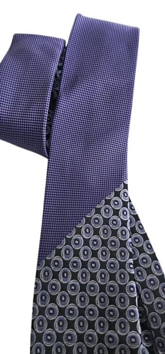 Close-up of a patterned tie with a blue and gray design on a white background