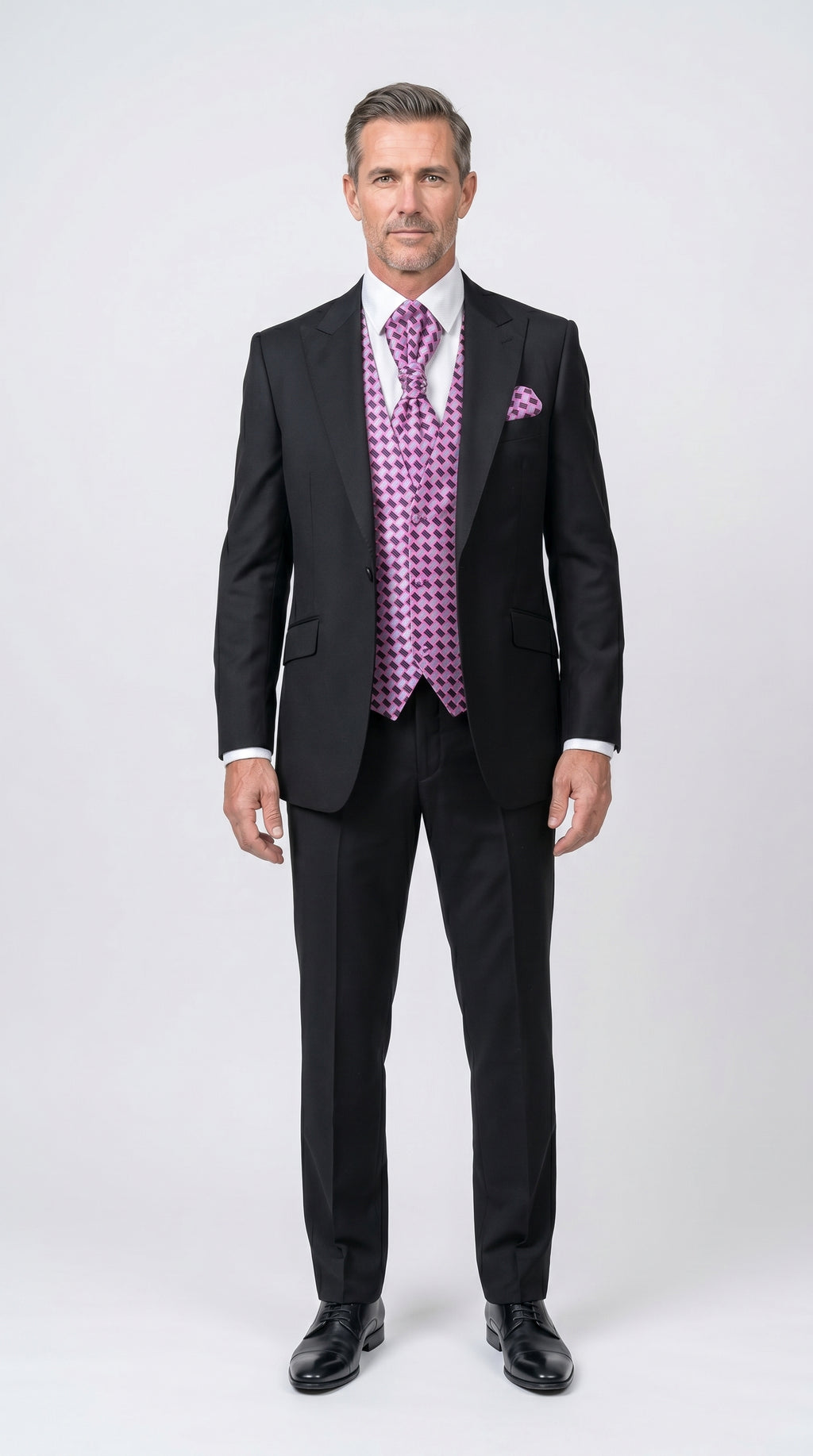 Man wearing a black suit with a purple vest and tie on a white background