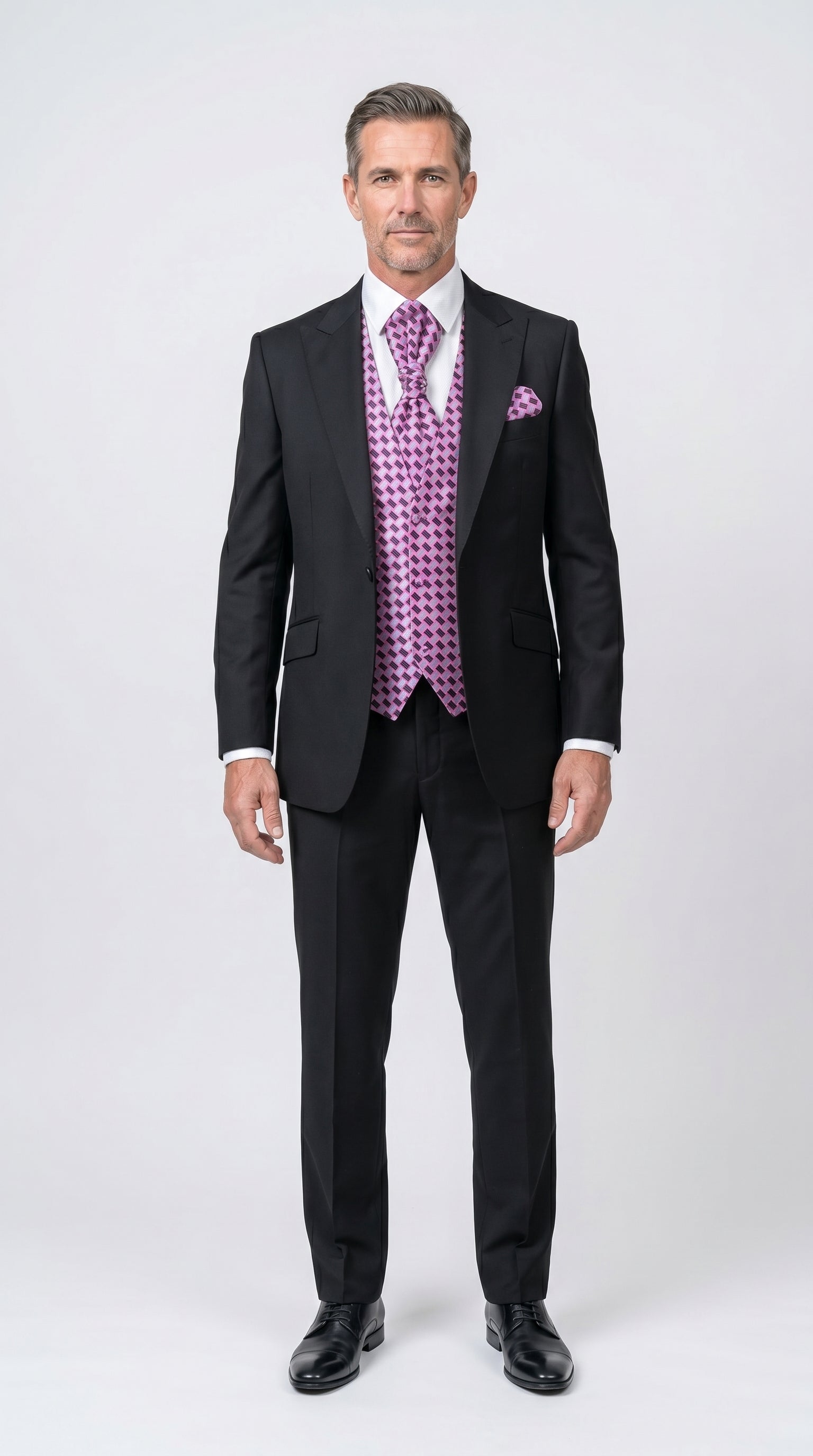 Man wearing a black suit with a purple vest and tie on a white background