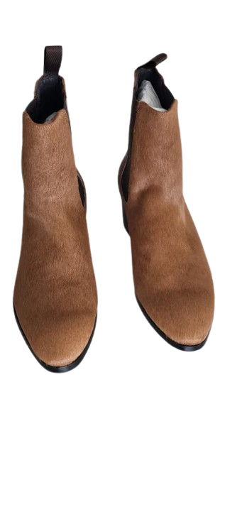 Pair of brown suede ankle boots on a white background