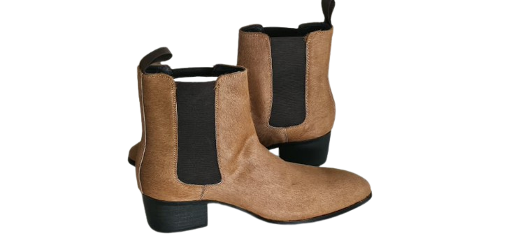 Pair of tan ankle boots with black elastic sides on a white background