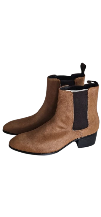 Pair of brown leather ankle boots with black elastic on a white background