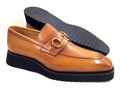 Brown loafer shoe with gold buckle on a white background