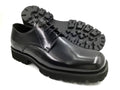 Black leather shoe with a thick sole on a white background