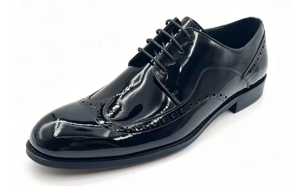A single black patent leather oxford wingtip shoe with brogue detailing and laces, photographed on a clean white background.